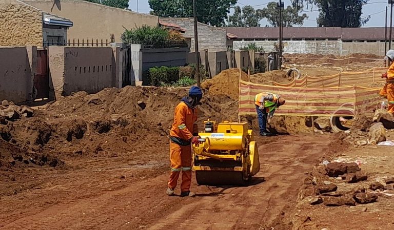 Vibratory roller compacting the road sub-base
